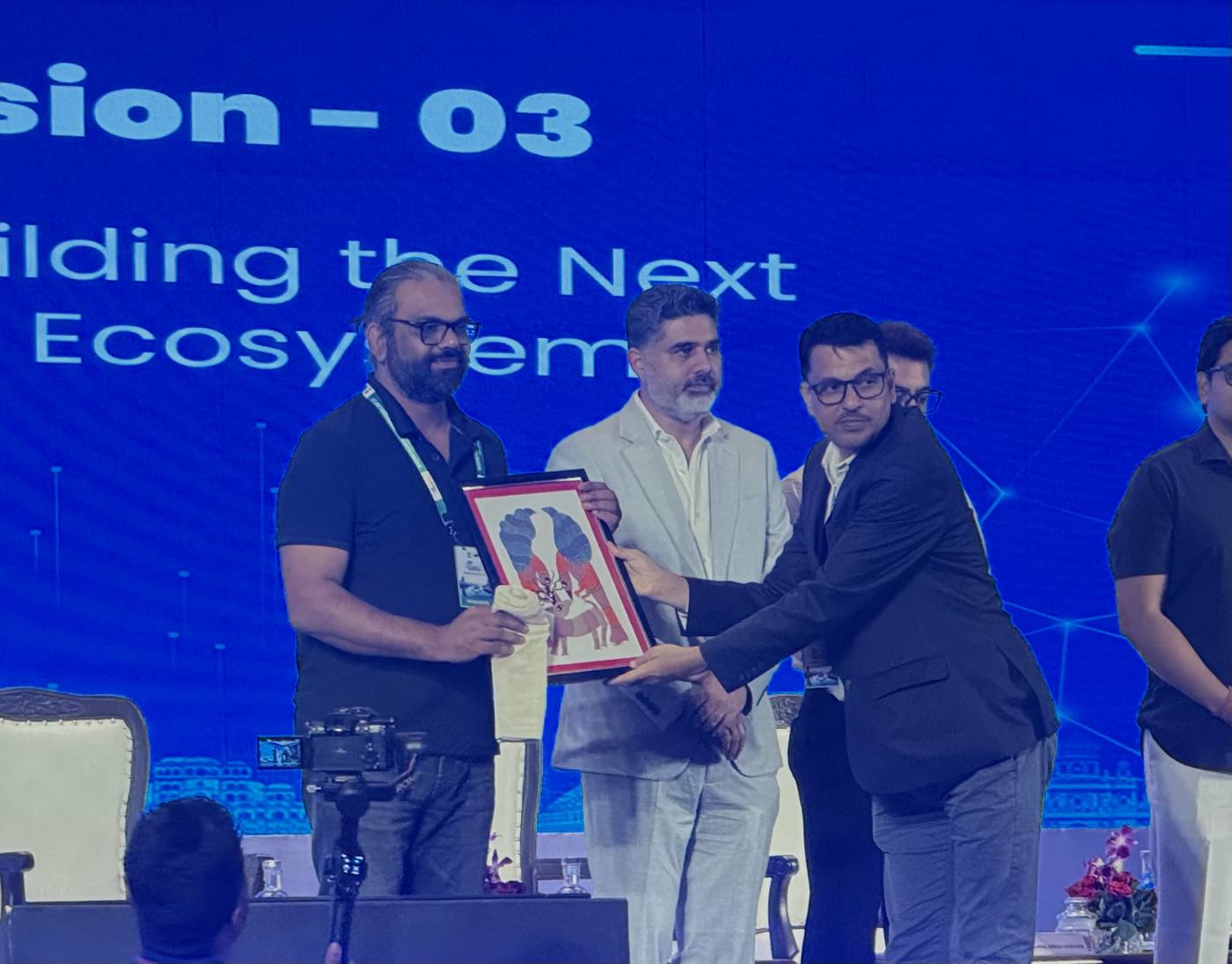 Gautam Yadav receiving a memento after a conclave session